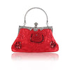 The Cosette Beaded Clutch by ElleRebel Curated is a red, vintage-inspired statement evening bag featuring a silver handle and ornate clasp. Adorned with embroidered and sequined floral designs, this elegant handbag is beautifully displayed on a white background with a subtle reflection beneath it—a true vintage beaded accessory perfect for any sophisticated occasion.